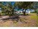 Spacious RV parking under covered structure, surrounded by trees at 29350 Goodhue St, Punta Gorda, FL 33982