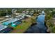 Aerial view of canal-front home with pool and lush landscaping at 3448 Middletown St, Port Charlotte, FL 33952