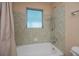 Bathroom with tub, shower, and tiled walls at 3448 Middletown St, Port Charlotte, FL 33952