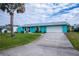 Single story turquoise home with a white garage door at 3448 Middletown St, Port Charlotte, FL 33952