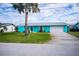 Charming turquoise home with a white garage door and palm tree at 3448 Middletown St, Port Charlotte, FL 33952