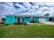 Bright turquoise home with white garage and lawn at 3448 Middletown St, Port Charlotte, FL 33952