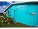 Teal home exterior with side door and plants at 3448 Middletown St, Port Charlotte, FL 33952