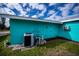 Home's exterior showcasing teal paint and AC unit at 3448 Middletown St, Port Charlotte, FL 33952