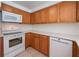 Kitchen with white appliances and wood cabinets at 3448 Middletown St, Port Charlotte, FL 33952