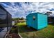 Bright teal storage shed in backyard at 3448 Middletown St, Port Charlotte, FL 33952