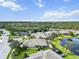 Aerial view of a community with houses, lush landscaping, and a lake at 3717 Lakewood Blvd, North Port, FL 34287