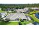 Aerial view of a house with a screened-in pool and lush landscaping at 3717 Lakewood Blvd, North Port, FL 34287