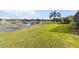 Landscaped backyard with lake view and lush grass at 3717 Lakewood Blvd, North Port, FL 34287