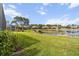 Landscaped backyard with a scenic lake view and community view at 3717 Lakewood Blvd, North Port, FL 34287