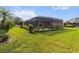 Screened lanai with lush landscaping in the backyard at 3717 Lakewood Blvd, North Port, FL 34287