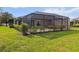 Screened-in patio with manicured hedges and lawn at 3717 Lakewood Blvd, North Port, FL 34287