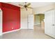 Simple bedroom with red walls and ceiling fan at 3717 Lakewood Blvd, North Port, FL 34287