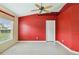 Bright bedroom with red walls and large window at 3717 Lakewood Blvd, North Port, FL 34287