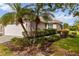 Tan house with garage and nicely landscaped yard at 3717 Lakewood Blvd, North Port, FL 34287