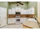 White kitchen with stainless steel appliances and tile backsplash at 3717 Lakewood Blvd, North Port, FL 34287