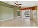 Living room with tile floors, neutral walls, and access to patio at 3717 Lakewood Blvd, North Port, FL 34287