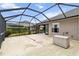 Backyard patio with screened enclosure and storage container at 3717 Lakewood Blvd, North Port, FL 34287