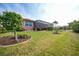 Single-story home with a screened-in patio and manicured landscaping at 3977 La Costa Island Ct, Punta Gorda, FL 33950