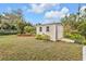 Large backyard with storage shed and lush greenery at 420 Chamber Nw St, Port Charlotte, FL 33948