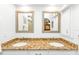 Bright bathroom with double sinks, granite countertops, and large mirrors at 420 Chamber Nw St, Port Charlotte, FL 33948