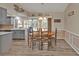 Bright dining room with wood table and gray kitchen cabinets at 420 Chamber Nw St, Port Charlotte, FL 33948