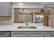 Modern kitchen with gray cabinets, quartz countertops, and a view of the pool at 420 Chamber Nw St, Port Charlotte, FL 33948