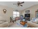 Bright living room featuring comfortable seating, a large TV, and a ceiling fan at 420 Chamber Nw St, Port Charlotte, FL 33948