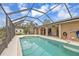 Inviting swimming pool with a screened enclosure at 420 Chamber Nw St, Port Charlotte, FL 33948