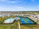 Aerial view of community pool, pickleball, and tennis courts at 44259 Saddlewood Ct, Punta Gorda, FL 33982