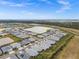 Aerial view of a community with houses, ponds, and landscaping at 44259 Saddlewood Ct, Punta Gorda, FL 33982