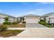 House exterior with attached garage and neatly landscaped front yard at 44259 Saddlewood Ct, Punta Gorda, FL 33982