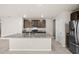 Kitchen island with granite countertop and dark brown cabinets at 44259 Saddlewood Ct, Punta Gorda, FL 33982