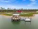 Lakefront gazebo with dock and red community building at 44259 Saddlewood Ct, Punta Gorda, FL 33982