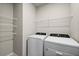 Laundry room with Whirlpool washer and dryer, and shelving at 44259 Saddlewood Ct, Punta Gorda, FL 33982