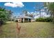 Large backyard with grassy area and home view at 4522 Mckay St, North Port, FL 34286