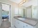 Bathroom with a vanity, granite countertop, and a view of the bedroom at 4522 Mckay St, North Port, FL 34286