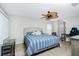 Bedroom with striped bedding, ceiling fan, and workspace at 4522 Mckay St, North Port, FL 34286