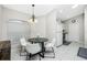 Four-chair dining area with modern chandelier and view of kitchen at 4522 Mckay St, North Port, FL 34286