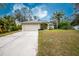 House with a driveway and manicured lawn at 4522 Mckay St, North Port, FL 34286