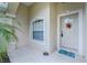 Front door entrance with a wreath and a welcome mat at 4522 Mckay St, North Port, FL 34286