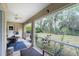 Relaxing screened porch with patio furniture and view of backyard at 4522 Mckay St, North Port, FL 34286