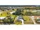 Aerial view of a house and surrounding community, showing expansive green spaces and water at 500 Woodstork Ln, Punta Gorda, FL 33982