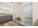 Elegant bathroom with a walk-in shower, double vanity, and tiled floors at 500 Woodstork Ln, Punta Gorda, FL 33982