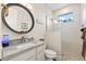 Modern bathroom with a walk-in shower, granite vanity, and updated fixtures at 500 Woodstork Ln, Punta Gorda, FL 33982