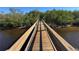 Wooden boardwalk path through lush mangrove trees leading to the waterfront at 500 Woodstork Ln, Punta Gorda, FL 33982