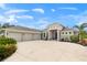 Three-car garage and front entrance of a single-Gathering home at 500 Woodstork Ln, Punta Gorda, FL 33982