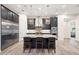 Modern kitchen with dark cabinetry, granite counters, and island seating at 500 Woodstork Ln, Punta Gorda, FL 33982