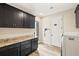 Laundry room with dark cabinets, granite countertops, and a washer/dryer at 500 Woodstork Ln, Punta Gorda, FL 33982