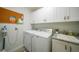 Laundry room with washer, dryer, cabinets and a sink at 526 Allen St, Punta Gorda, FL 33950